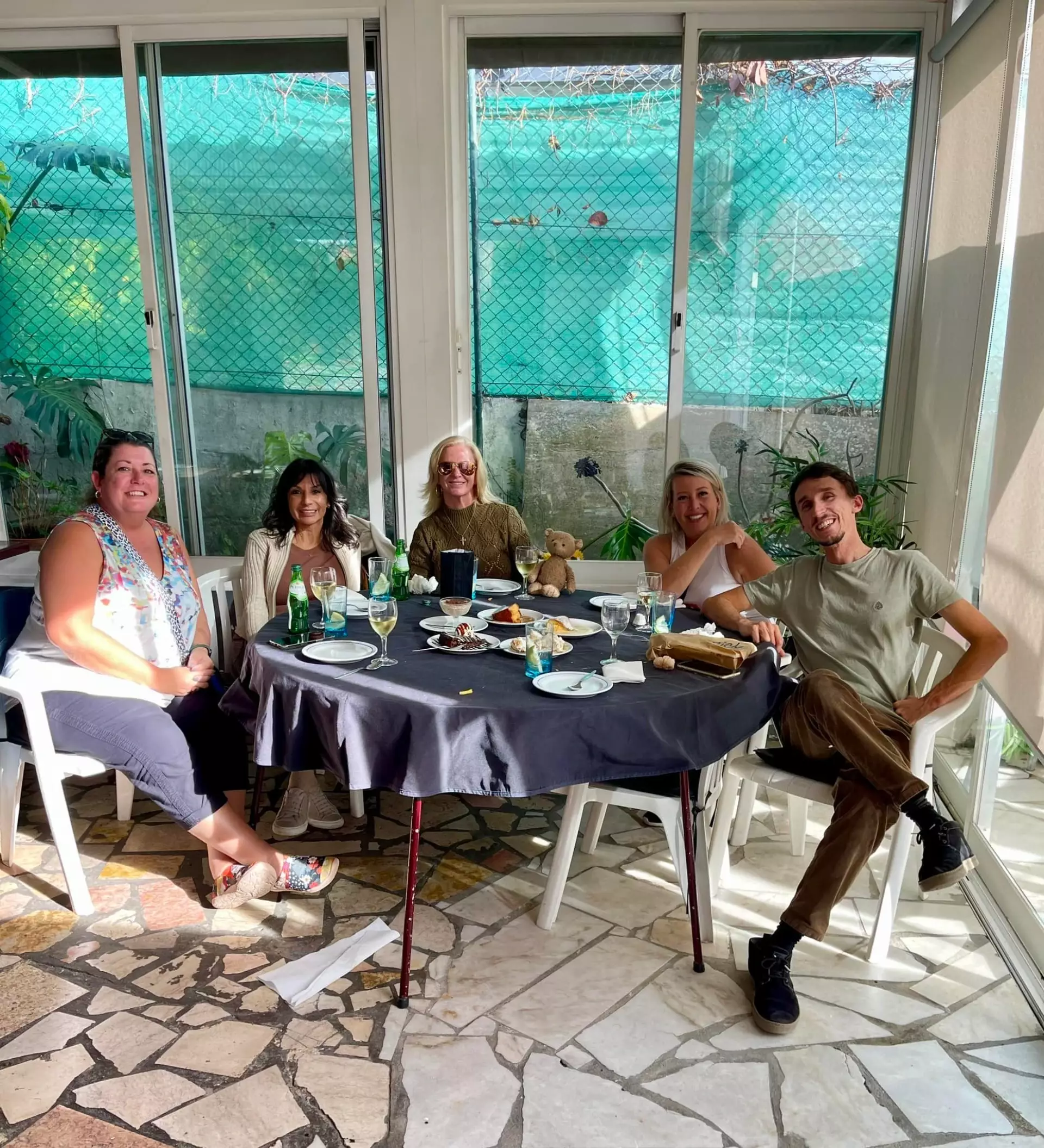 Private lunch experience during a Yes, You Deserve! tour in Sintra, Portugal – group of travelers enjoying local food, wine, and great conversation in a cozy, sunlit setting.