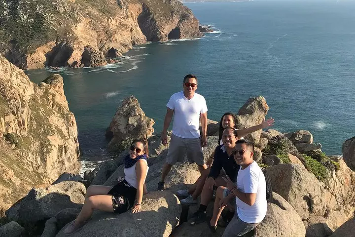 Group of tourists enjoying the view at Cabo da Roca, the westernmost point of mainland Europe, during a private Sintra and Cascais tour in Portugal.