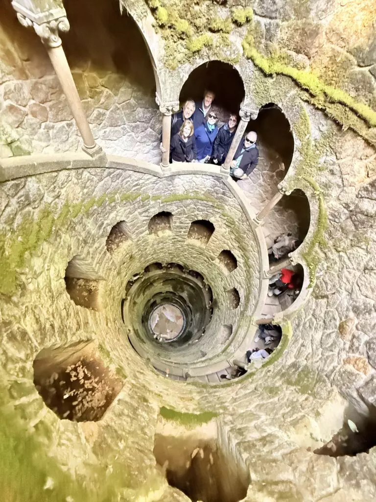 A cruise guest exploring the initiation well in quinta da regaleira in one of our tuk tuks — just 45 minutes after leaving Lisbon port.