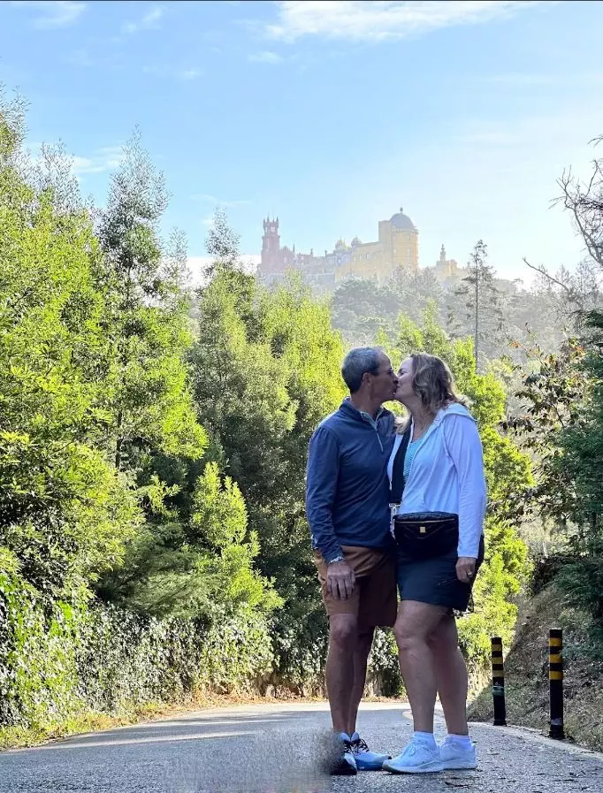 Couple viewing colorful palace on a hill.