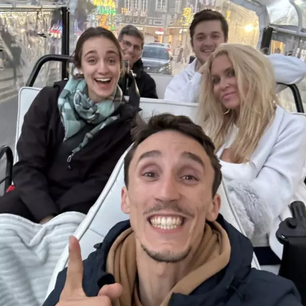 Private winter tuk tuk tour in Sintra with Daniel Ponce from Yes, You Deserve! – happy travelers bundled up for a magical evening ride through Portugal's charming town.