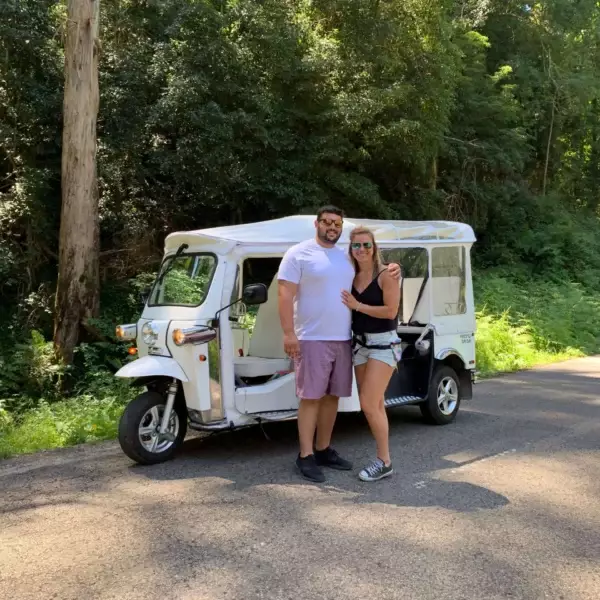 Couple enjoying a private Sintra tuk tuk tour through a scenic forest road with Yes, You Deserve – a romantic and unforgettable experience exploring Portugal’s natural beauty and hidden gems.