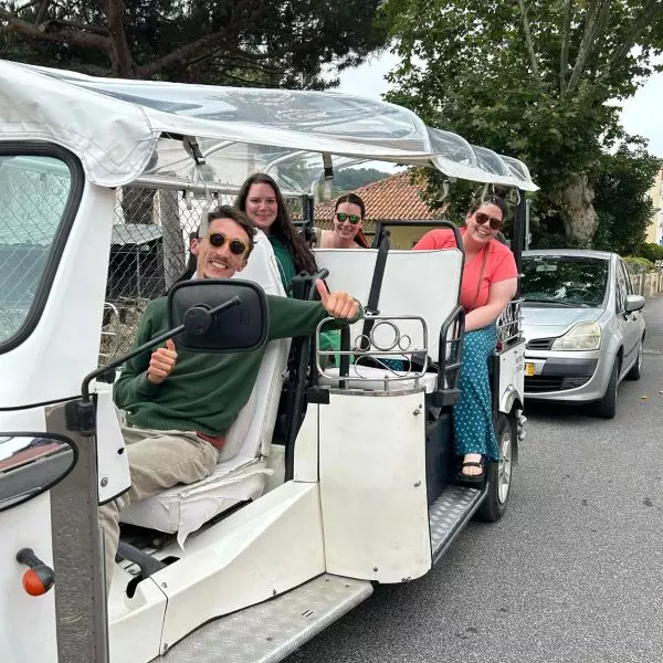 Private tuk-tuk tour in Sintra, Portugal with smiling guide Daniel Ponce and three happy visitors enjoying the experience – Yes, You Deserve.